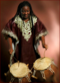 vigorously playing the ghananian drums